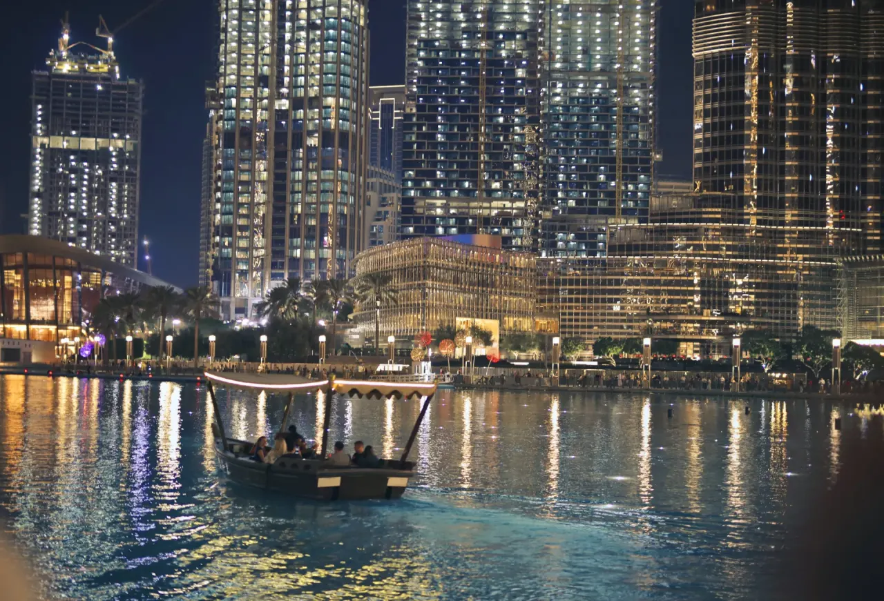 An abra on the Dubai Mall lake at night